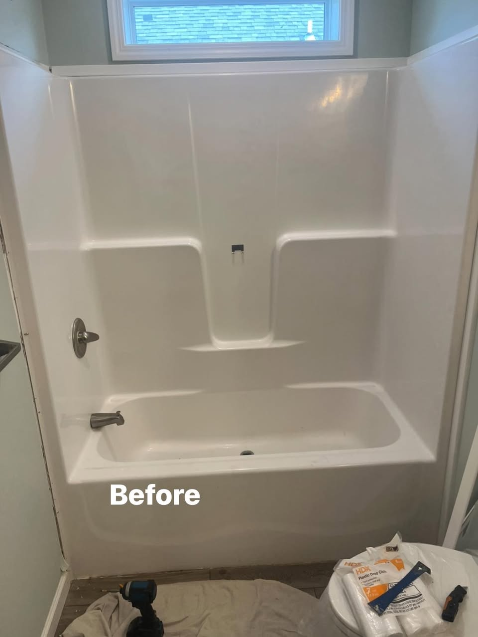 Bathtub and shower surround before bathroom renovation